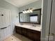 Bathroom boasts double sinks, a large mirror, and a view of the shower at 103 Berea Baptist Church Rd, Stanfield, NC 28163