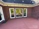 Red wooden deck with brick exterior and string lights at 103 Berea Baptist Church Rd, Stanfield, NC 28163