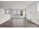 Large living room featuring hardwood floors and multiple windows at 1710 Blanche St, Charlotte, NC 28262