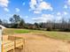 View of a spacious backyard with a wooden deck, grassy area, and trees at 4085 Miller Rd, Salisbury, NC 28146