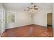 Spacious bedroom with hardwood floors and ceiling fan at 4094 Deerfield Nw Dr, Concord, NC 28027