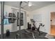 Home gym featuring a Peloton bike and weight training equipment at 1000 E Woodlawn Rd # 415, Charlotte, NC 28209