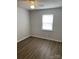 Bright bedroom with wood-look floors and window at 2924 Hosta Dr, Charlotte, NC 28269