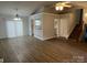 Open living area with kitchen pass-through and stairs at 2924 Hosta Dr, Charlotte, NC 28269