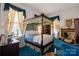 Serene bedroom with a four-poster bed and blue carpet at 104 Leslie Loop, Mooresville, NC 28115