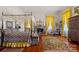 Elegant bedroom with a four-poster bed, fireplace, and yellow curtains at 104 Leslie Loop, Mooresville, NC 28115
