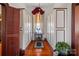 Long hallway with built-in closets and hardwood floors at 104 Leslie Loop, Mooresville, NC 28115