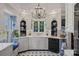 Bright kitchen with white cabinets, blue accents and a chandelier at 104 Leslie Loop, Mooresville, NC 28115