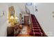Grand curved staircase with a rich red runner at 104 Leslie Loop, Mooresville, NC 28115
