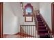 Grand staircase with red carpet runner and a view of the landing at 104 Leslie Loop, Mooresville, NC 28115
