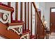 Wooden staircase with red carpet and intricate detailing at 104 Leslie Loop, Mooresville, NC 28115