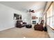 Gathering room with fireplace, brown leather furniture, and ceiling fan at 435 Riverwalk Nw Dr, Concord, NC 28027