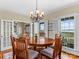 Dining room with a view, featuring a round table and access to other rooms at 806 Lake Mist Dr, Stanley, NC 28164