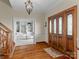 Elegant entryway with hardwood floors, a view into the living area, and a beautiful wooden door at 806 Lake Mist Dr, Stanley, NC 28164