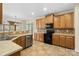 Modern kitchen with wood cabinets and tile floors at 129 Winterbell Dr, Mooresville, NC 28115