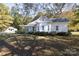 White farmhouse with a large yard and detached shed at 130 Shiloh Rd, Troy, NC 27371