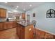 Kitchen island with seating and granite countertop, offering extra prep space at 26508 Sandpiper Ct, Fort Mill, SC 29707