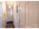 Long hallway with white walls, white doors, and wood floors at 130 Shiloh Rd, Troy, NC 27371