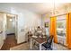 Well-lit dining area with orange curtains and wood floors at 130 Shiloh Rd, Troy, NC 27371