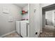 Convenient laundry room with washer, dryer, and overhead shelving at 1568 Whitman Ct, York, SC 29745