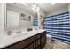 Bathroom boasts a double vanity, large mirror, and striped shower curtain at 1568 Whitman Ct, York, SC 29745