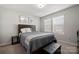 Cozy bedroom with a queen-size bed, nightstand, and window coverings at 1568 Whitman Ct, York, SC 29745