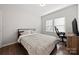 Bright bedroom with a queen bed, desk, and large windows at 1568 Whitman Ct, York, SC 29745