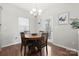 Cozy dining area with wood table and chairs, adjacent to a sliding glass door at 1568 Whitman Ct, York, SC 29745