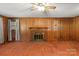 Living room with brick fireplace and wood paneled walls at 1102 W Elm St, Shelby, NC 28152