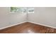 Spacious bedroom with hardwood floors and two windows at 1102 W Elm St, Shelby, NC 28152