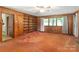 Living room with built-in shelving and wood paneled walls at 1102 W Elm St, Shelby, NC 28152