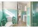 Green tiled bathroom with toilet and shower at 1102 W Elm St, Shelby, NC 28152