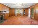 Spacious living room with wood paneling, fireplace, and a ceiling fan at 1102 W Elm St, Shelby, NC 28152