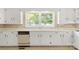 Kitchen with white cabinets, dishwasher, and double sink at 1102 W Elm St, Shelby, NC 28152
