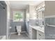 Clean bathroom with light blue tile and vanity at 1102 W Elm St, Shelby, NC 28152