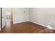 Hardwood floor bedroom with access to bathroom at 1102 W Elm St, Shelby, NC 28152