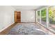 Living room with hardwood floors, large windows, and access to patio at 1102 W Elm St, Shelby, NC 28152