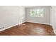 Well-lit bedroom featuring hardwood floors and a large window at 1102 W Elm St, Shelby, NC 28152