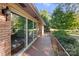 Long side porch with brick flooring and metal railing at 1102 W Elm St, Shelby, NC 28152