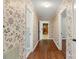 Hallway with wood floors and floral wallpaper at 1102 W Elm St, Shelby, NC 28152