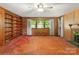 Living room featuring built-in shelving, wood paneling, and hardwood floors at 1102 W Elm St, Shelby, NC 28152