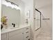 Bathroom with white vanity, quartz countertop, and frameless shower at 103 Buck Hill Rd, Monroe, NC 28112