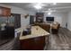 Open floor plan with kitchen island, stone fireplace, and hardwood floors at 907 Bethlehem Rd, Kings Mountain, NC 28086