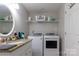 Basement bathroom with laundry, vanity, and linen storage at 907 Bethlehem Rd, Kings Mountain, NC 28086