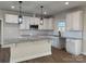 Modern kitchen with white cabinets, granite countertops, and a large island at 723 E Memorial Hwy, Harmony, NC 28634