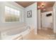 Relaxing bathroom featuring a soaking tub and shower at 7894 Woodmere Dr, Harrisburg, NC 28075