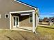 Side view of a house with covered patio and grilling area at 13326 Blanton Dr, Huntersville, NC 28078