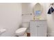 Clean bathroom with white vanity, oval mirror and hardwood floor at 3714 Radbourne Blvd, Charlotte, NC 28269