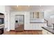 White kitchen cabinetry, stainless steel refrigerator, and hardwood floors at 3714 Radbourne Blvd, Charlotte, NC 28269