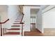 Grand staircase with a wooden railing and hardwood floors at 3714 Radbourne Blvd, Charlotte, NC 28269